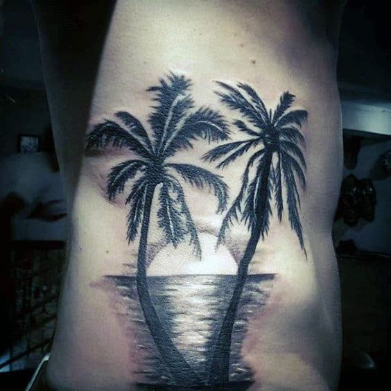 A beautiful design of the palm tree tattoo on  the body of a guy 