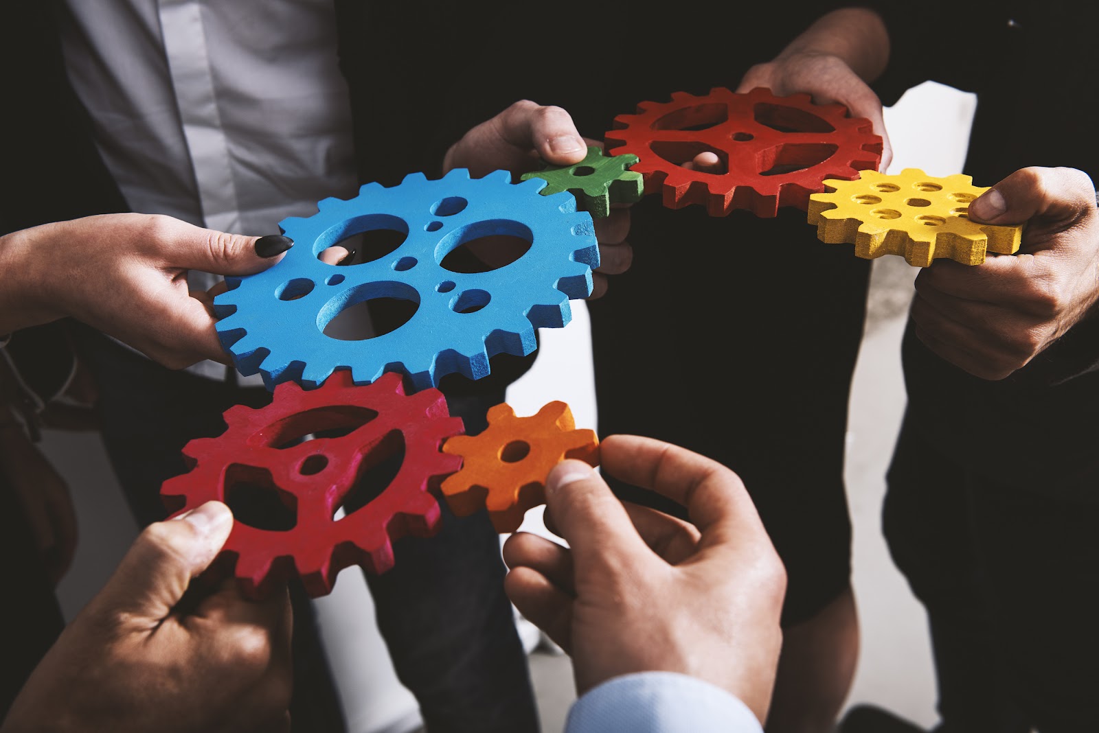 Group of people holding gears.