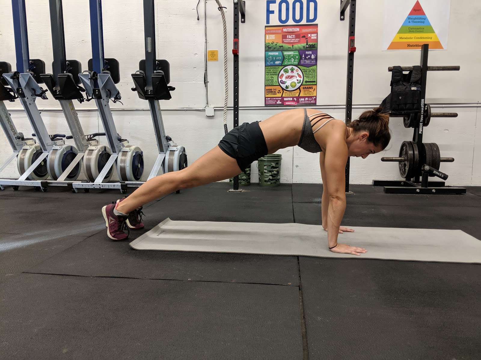 woman in gym doing a plank hold