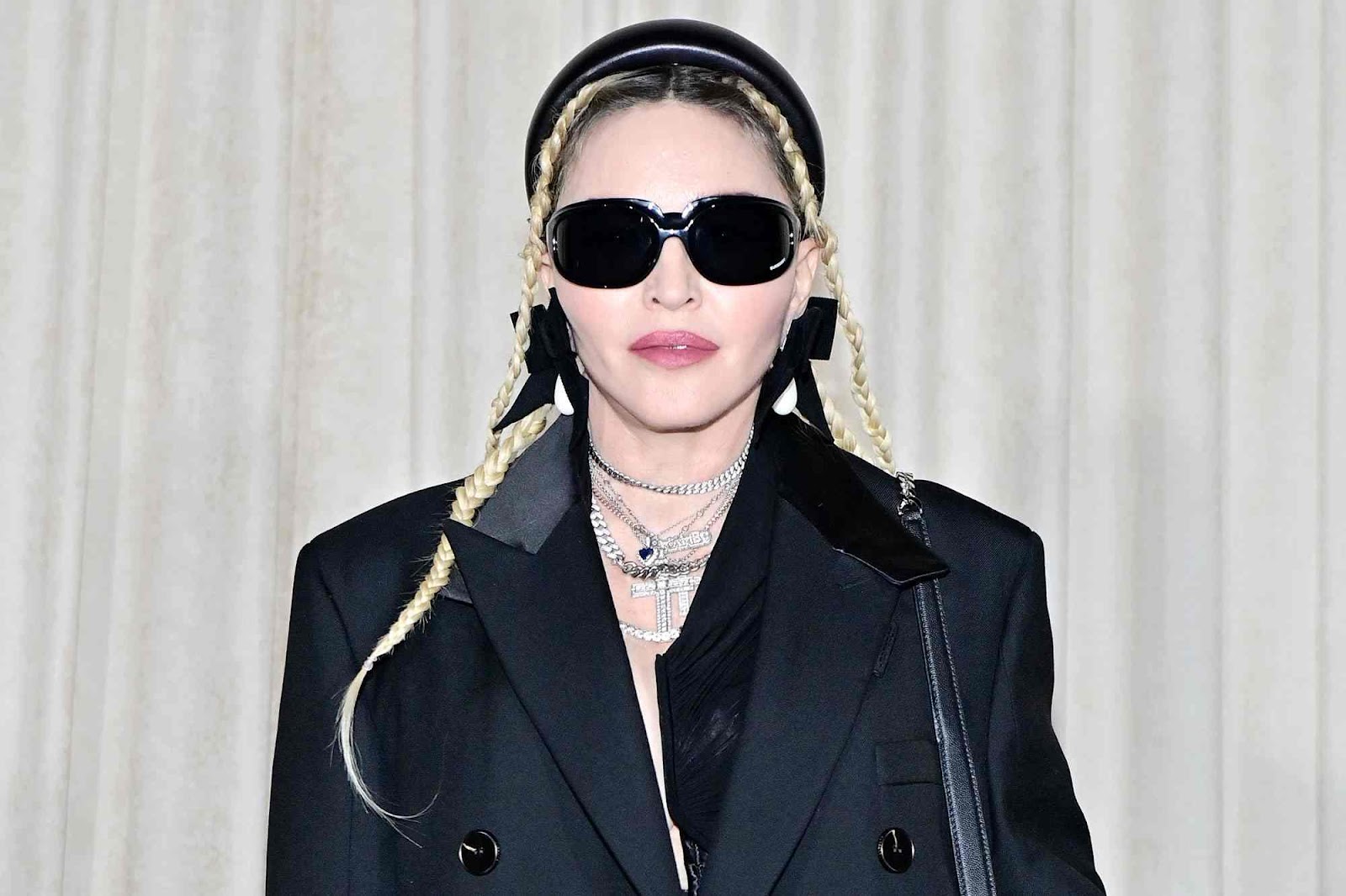 A person wearing sunglasses and a black jacket

Description automatically generated