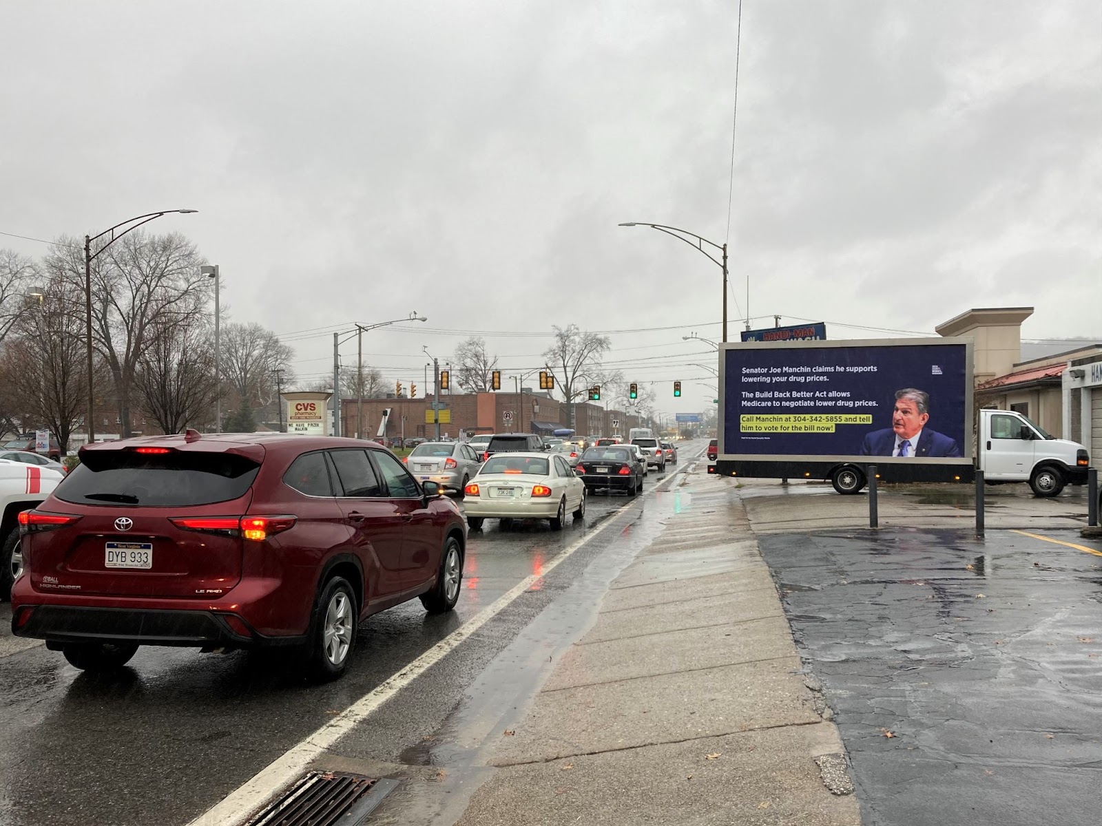 Image of the billboard truck parked off the side of a busy road
