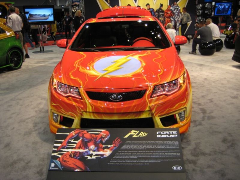 Orange car with the flash logo on the hood.