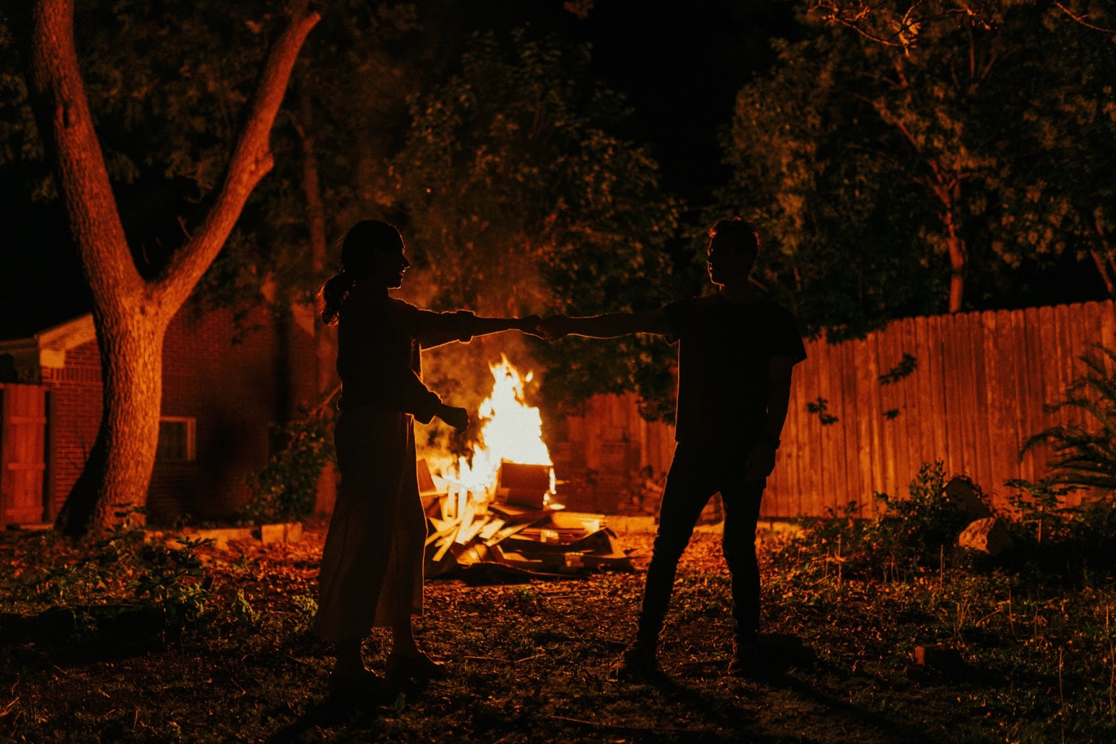 couple dancing by their bonfire