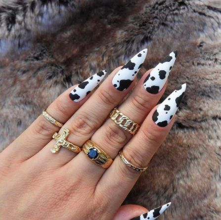 Full picture  rocking hand accessories on her cow print nails