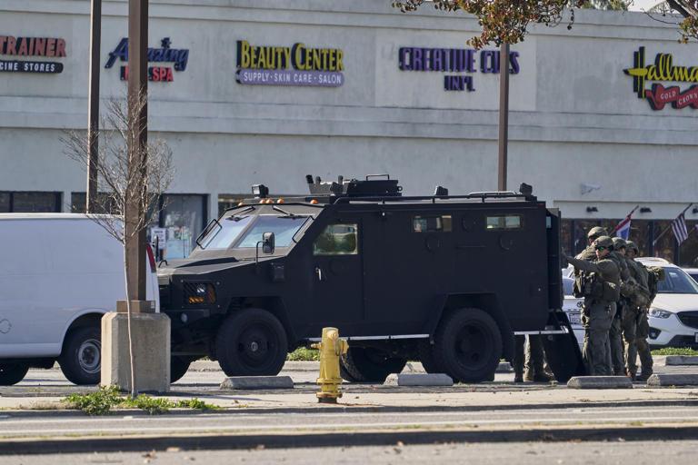 Law enforcement are seen outside the site in Torrance, Calif., where a man alleged to have killed ten people in Monterey Park, California, was believed to be holed up, on Jan. 22, 2023.