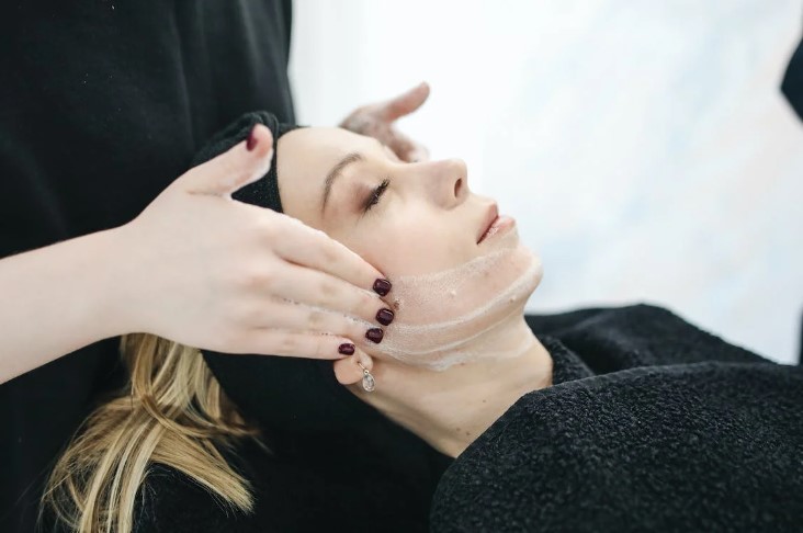 A client getting facial treatment service
