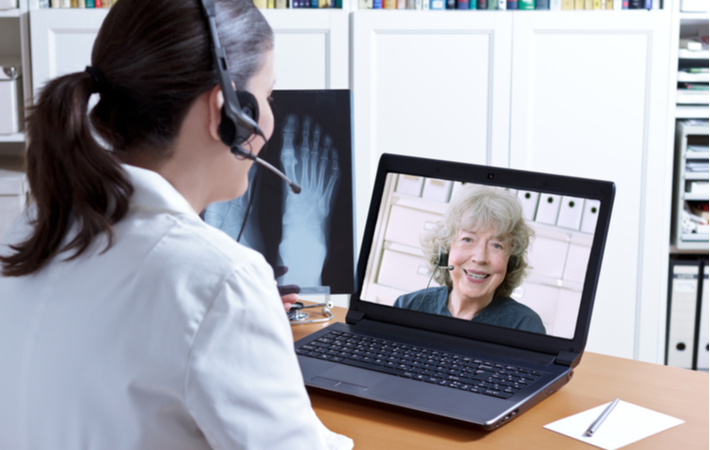 senior woman using video chat to contact her doctor