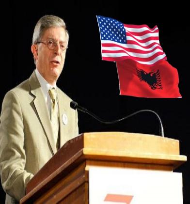 A person standing at a podium with a flag behind him

Description automatically generated with medium confidence