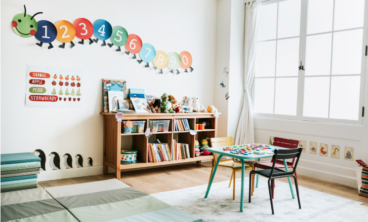 An organized playroom with a kids table and bookshelf