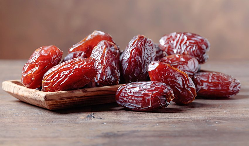 Medjool Dates photographed on a wooden table 
