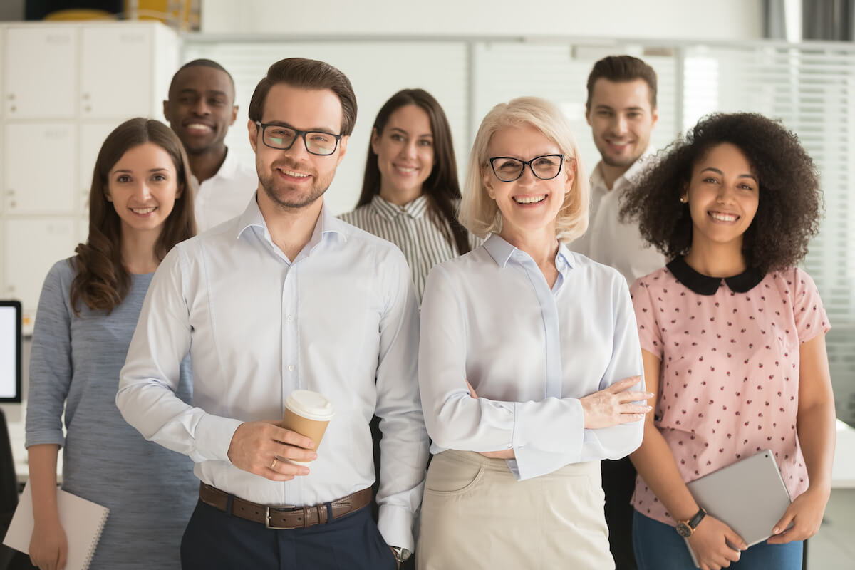 FMLA outsourcing: team of professionals smiling for a photo