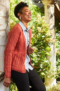 woman outside wearing a cable knit cardigan