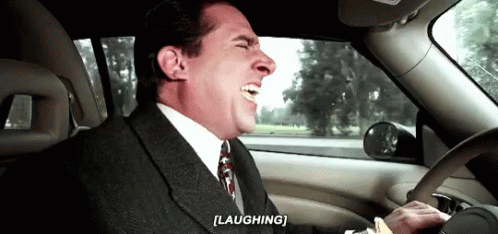 Man laughing driving car