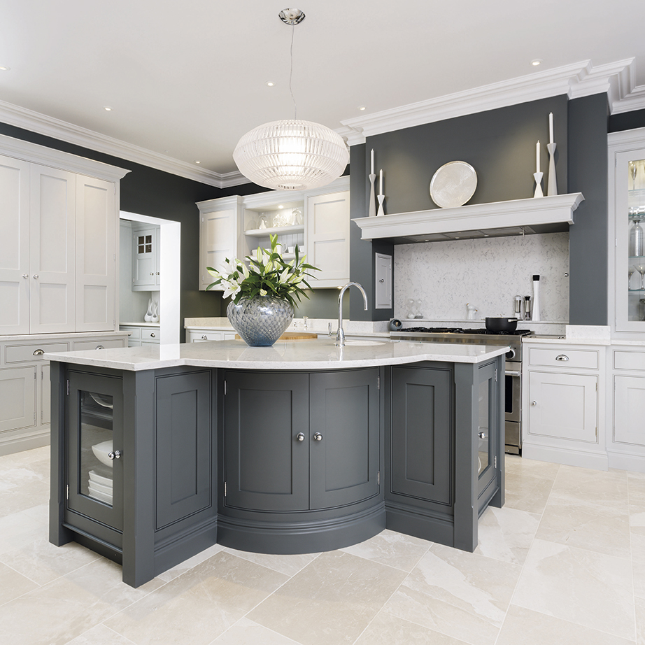 geometric l-shaped kitchen island in a grey and white kitchen design with light tile floors