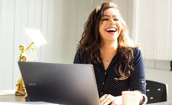 A person laughing while using a computer

Description automatically generated with medium confidence