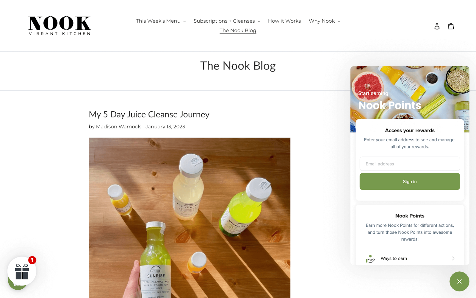 Nook Vibrant Kitchen–A screenshot from Nook’s website. The page is The Nook Blog and shows an article titled, “My 5 Day Juice Cleanse Journey”. The featured image is 5 multicolored bottles of juice on a wooden table. On the right side of the image is Nook’s rewards panel, which shows the title ‘Nook Points’ and has two sections visible: the sign-in bar and the points program explainer showing ways to earn and ways to redeem. 