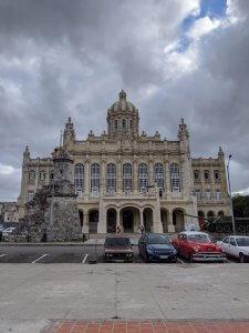 A large stone building with cars parked in front of it

Description automatically generated with medium confidence