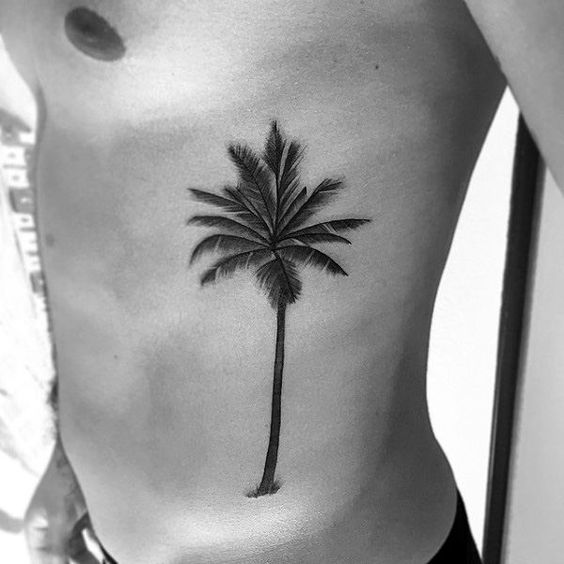 Guy shows off his palm tree tat on the side of his body 