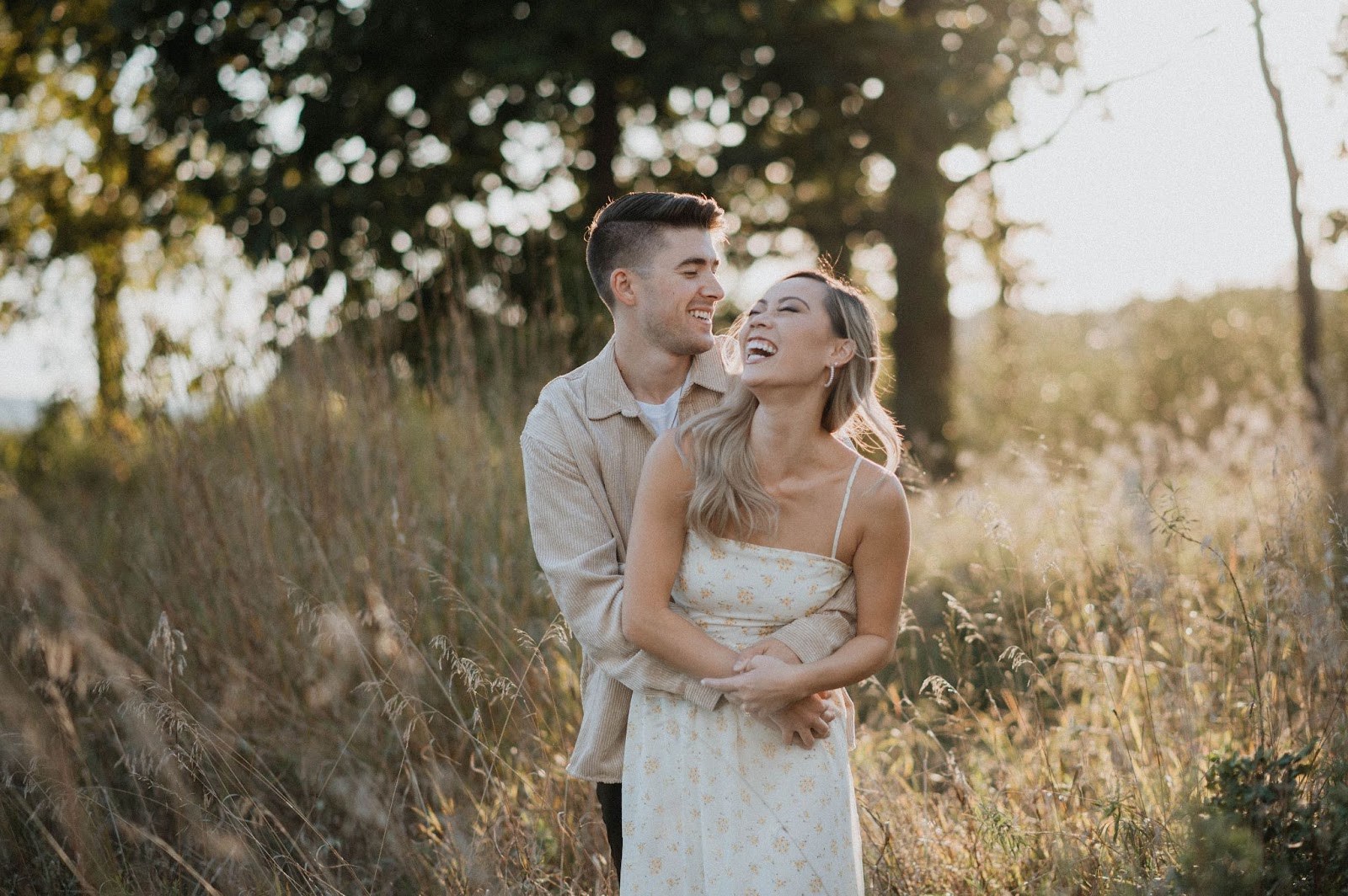 Smiling couple embracing in a natural pose.