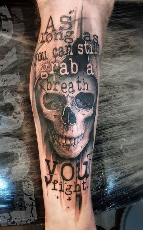 Full picture of a guy rocking the leg tattoo with   some quotes and phrases