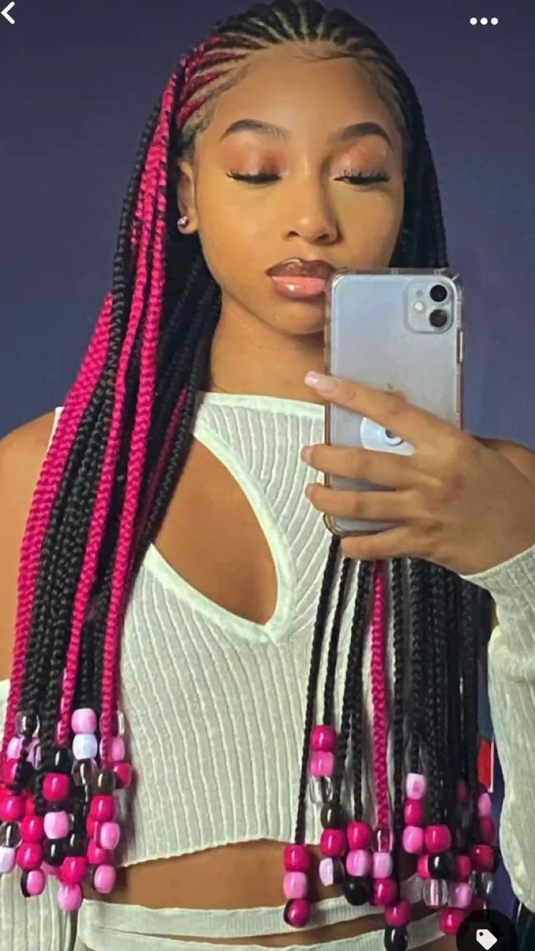 lady wearing red and black Fulani braids with colorful beads