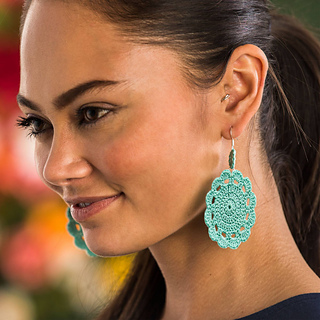 small crochet doily earrings modeled by woman