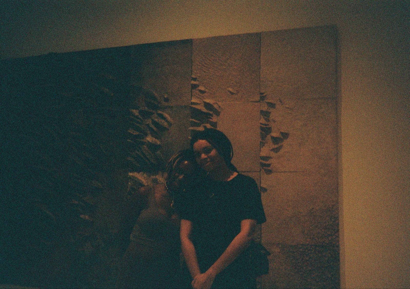 Image: Isra Rene and Imani Elizabeth Jackson standing in front of Sky Over Illinois, 1985. Two people stand in front of a large-scale work that has some texture on the surface. Courtesy of the author.