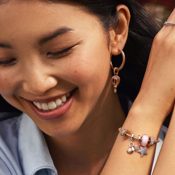 Lady shows off her beautiful dangling earrings with a smile