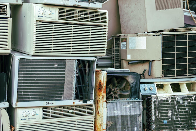 A pile of old air conditioners

Description automatically generated