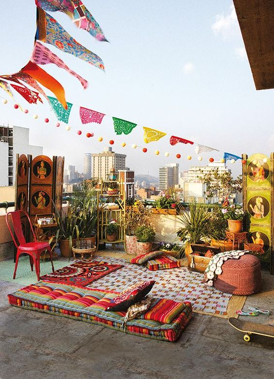 an organized balcony for sitting that have plants and chairs 