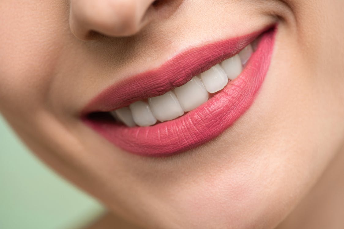 girl smiling with pearly white teeth and pink lipstick