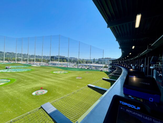 The opening of the Topgolf Renton-Seattle! A golfer teeing off at Topgolf Renton is a short distance away from Boeing in Renton.