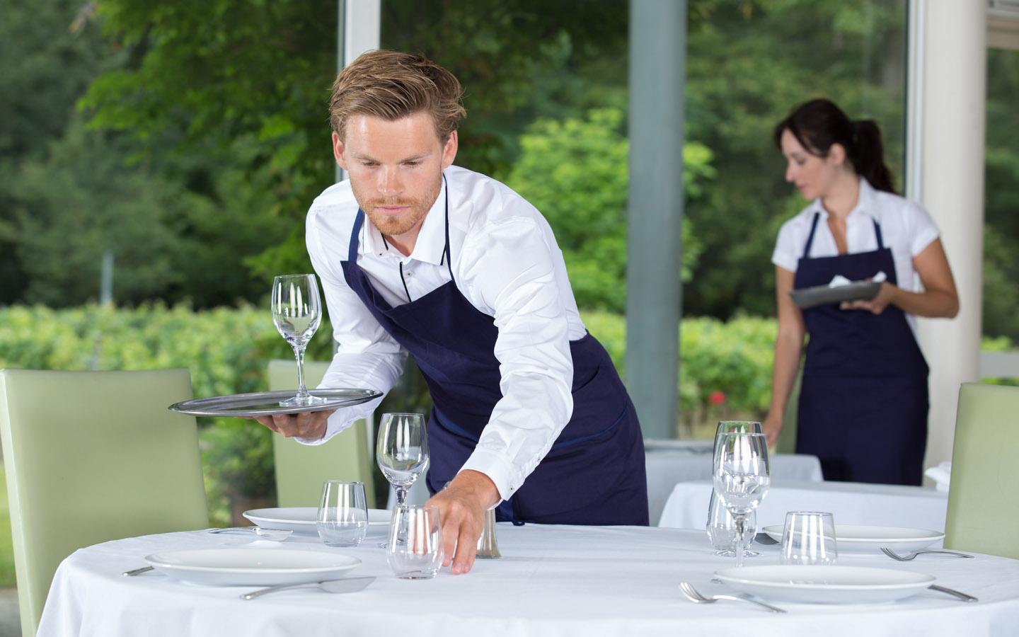 waiters setting glass on table