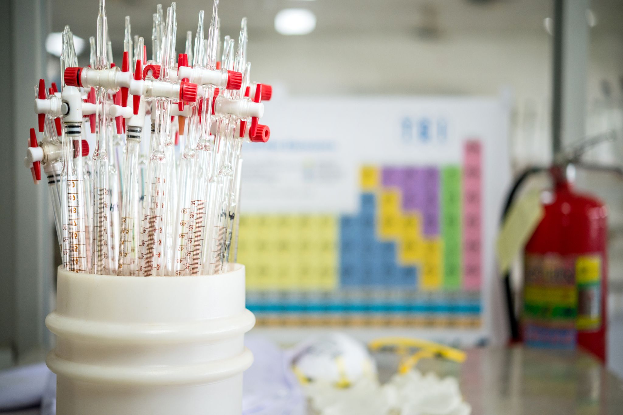 bucket of burettes in a laboratory setting