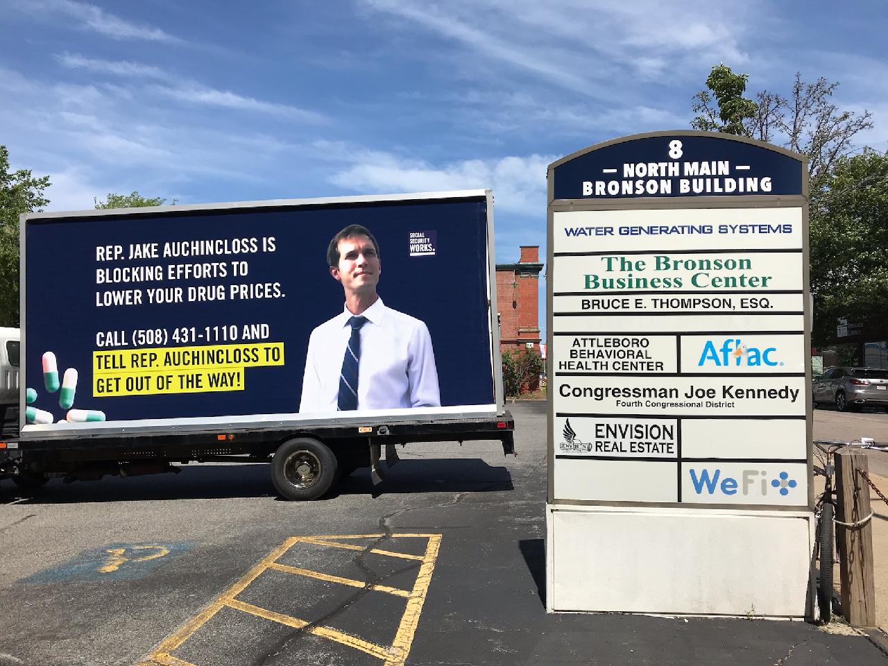 Image of our billboard truck, parked outside Rep. Auchincloss' office