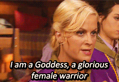 Gif featuring four women dressed in purple girl scout clothes. One of the women who has blond hair is saying "I am a Goddess, a glorious female warrior."