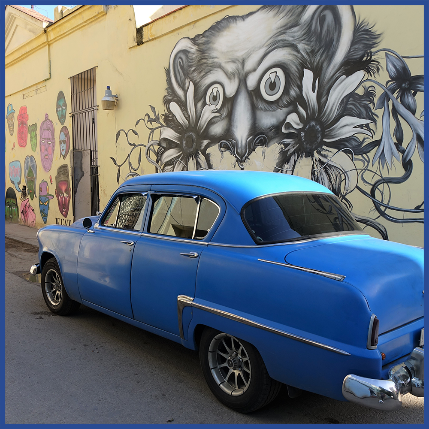 A blue car parked in front of a wall with art

Description automatically generated with medium confidence