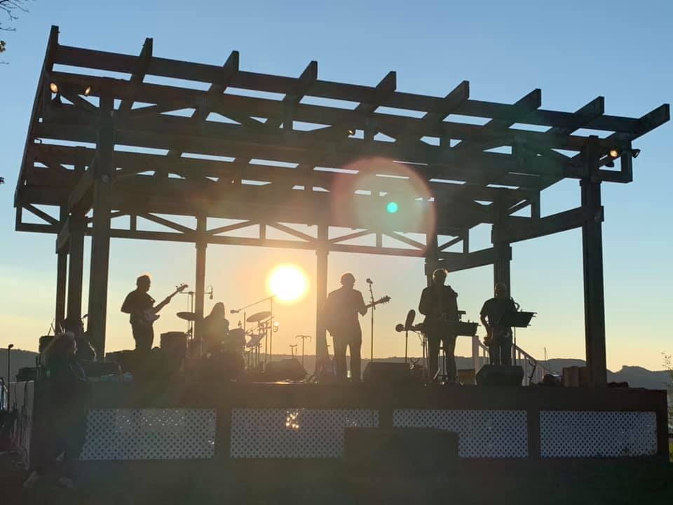 A photo of a band playing at sunset at the bandstand at Louis Engel Waterfront Park in Ossining, NY. 