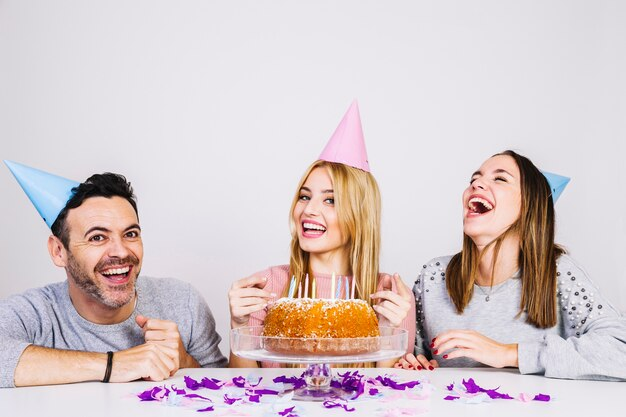 A woman celebrating birthday with friends while laughing and discussing Instagram Birthday Countdown Captions.