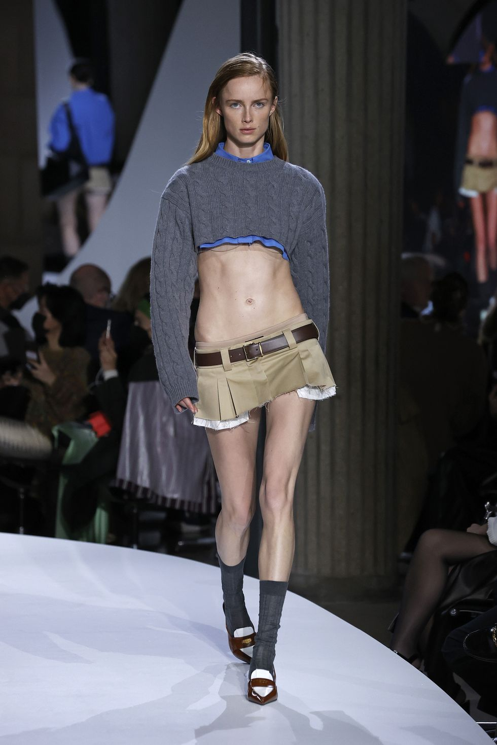 mode;l wearing crop top sweater on micro mini skirt on the catwalk