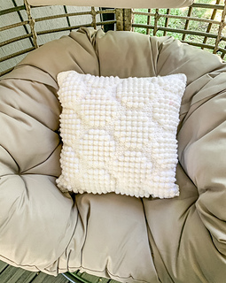 white crochet pillow with octagons created by bobble stitches