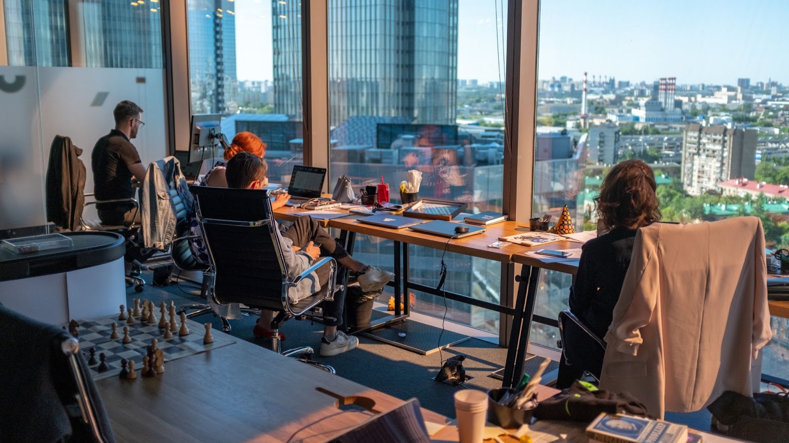 group of people in a windowed office room filled with devices and tools. How To Get An Internship At Blizzard