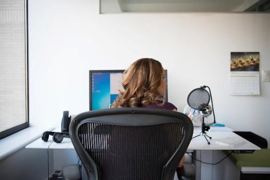 Free Woman Siting on Chair in Front of Turn on Computer Monitor Stock Photo