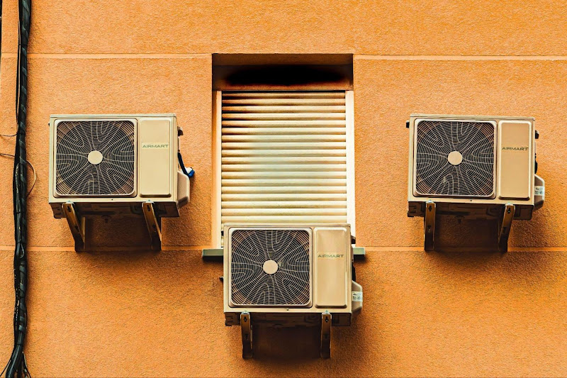 A group of air conditioners on a wall

Description automatically generated