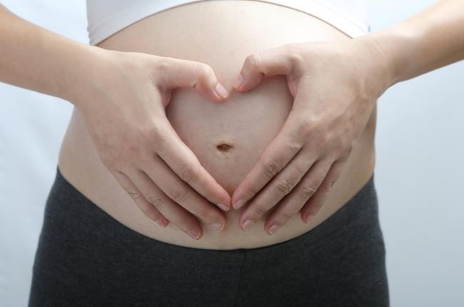 a women holding her pregnant tummy