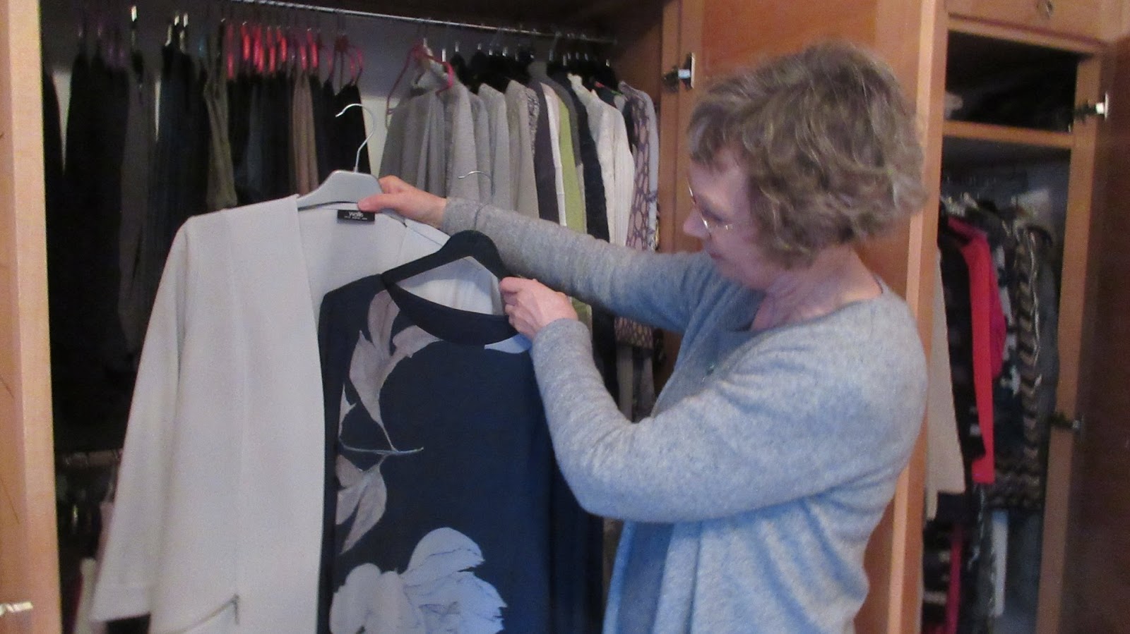 Woman choosing clothes from her wardrobe