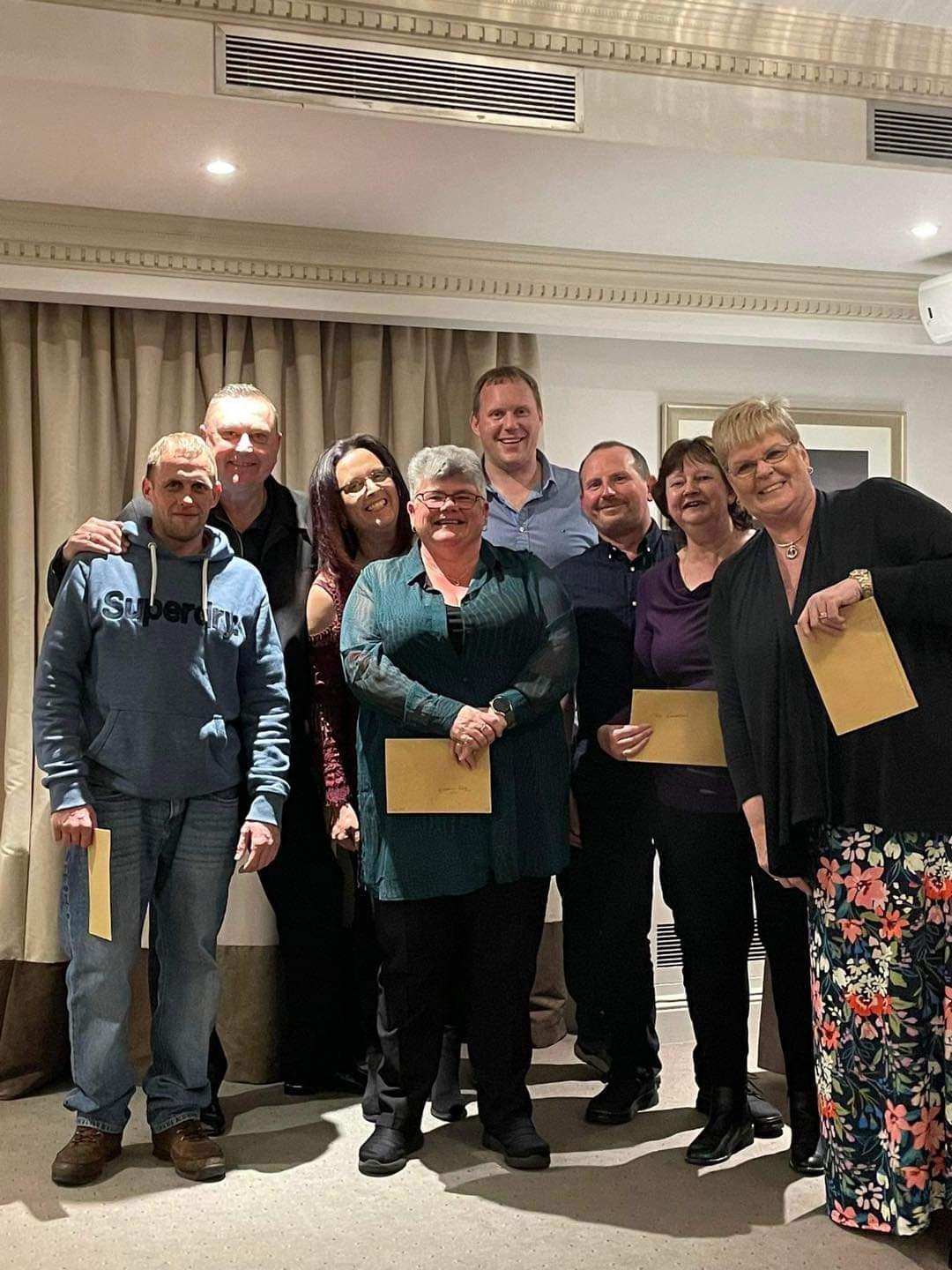 A group of people posing for a photo
Description automatically generated