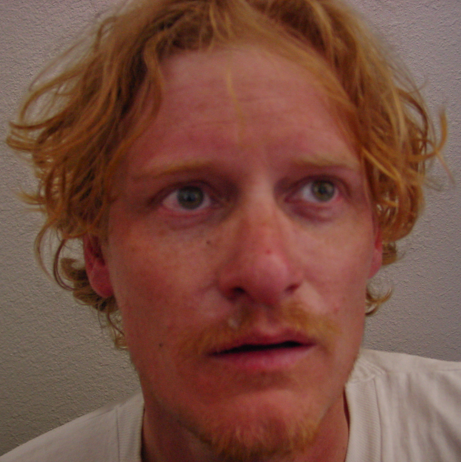 A photo of the author with disheveled hair and sunburned face. 