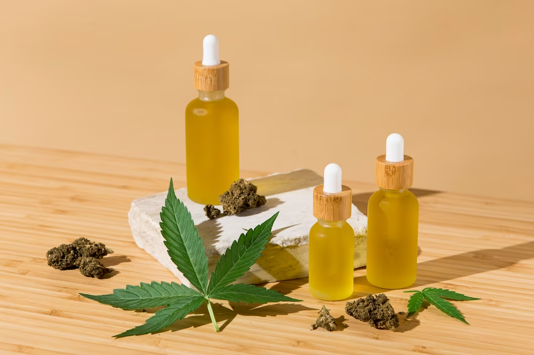 A group of bottles with a dropper next to a block of marijuanaDescription automatically generated