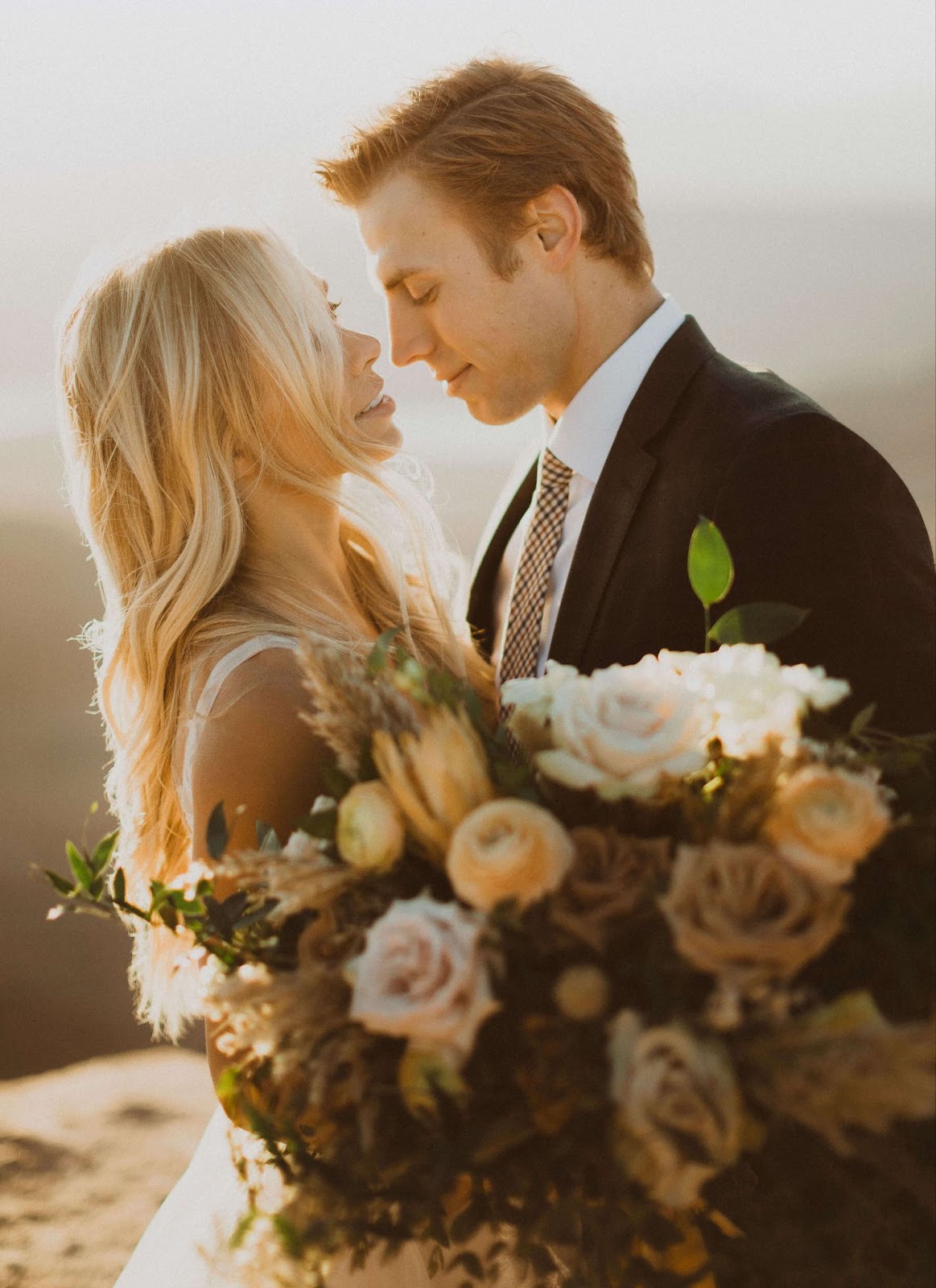 couple getting married holding flowers